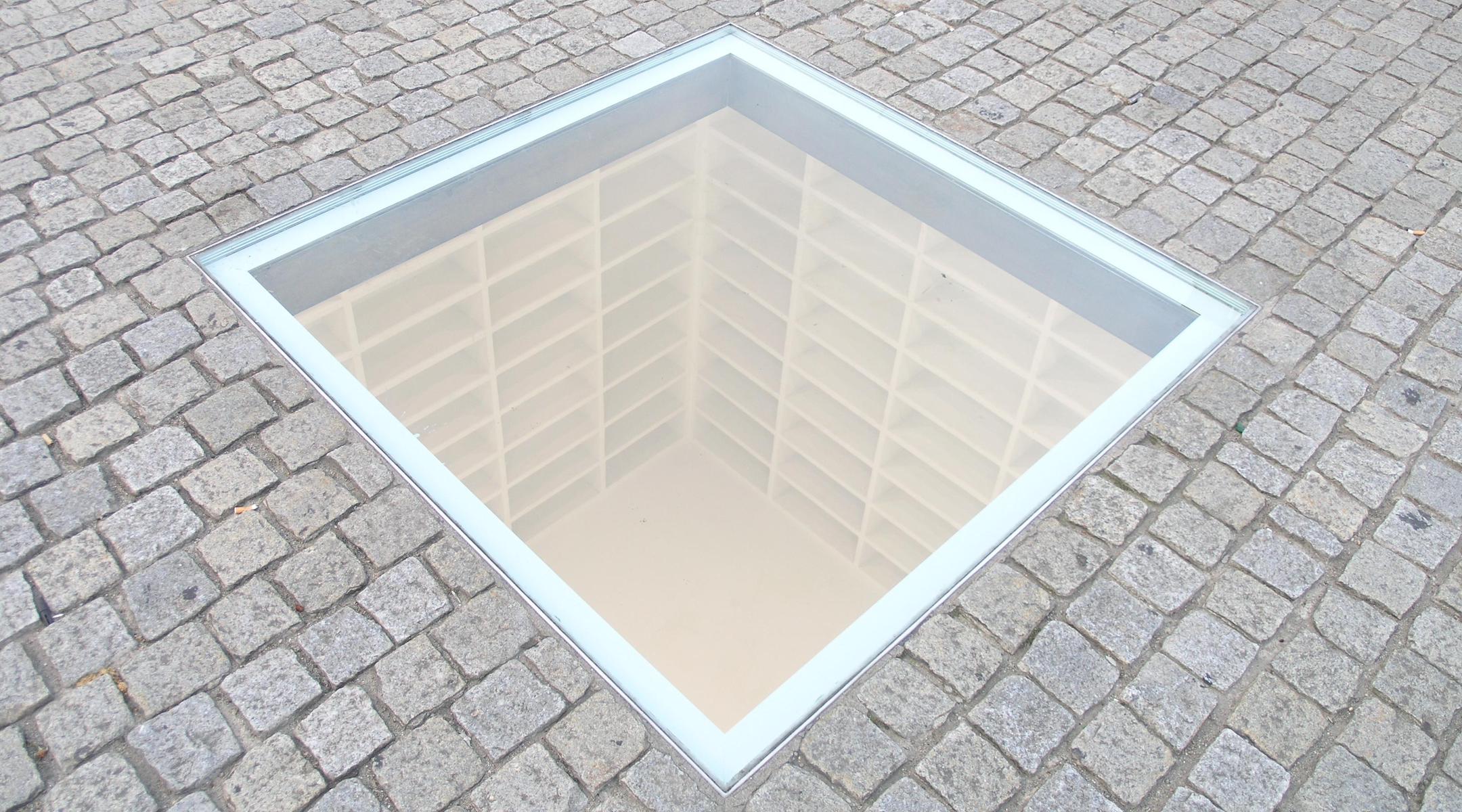 "The Empty Library," an all-white row of empty bookshelves, in Berlin