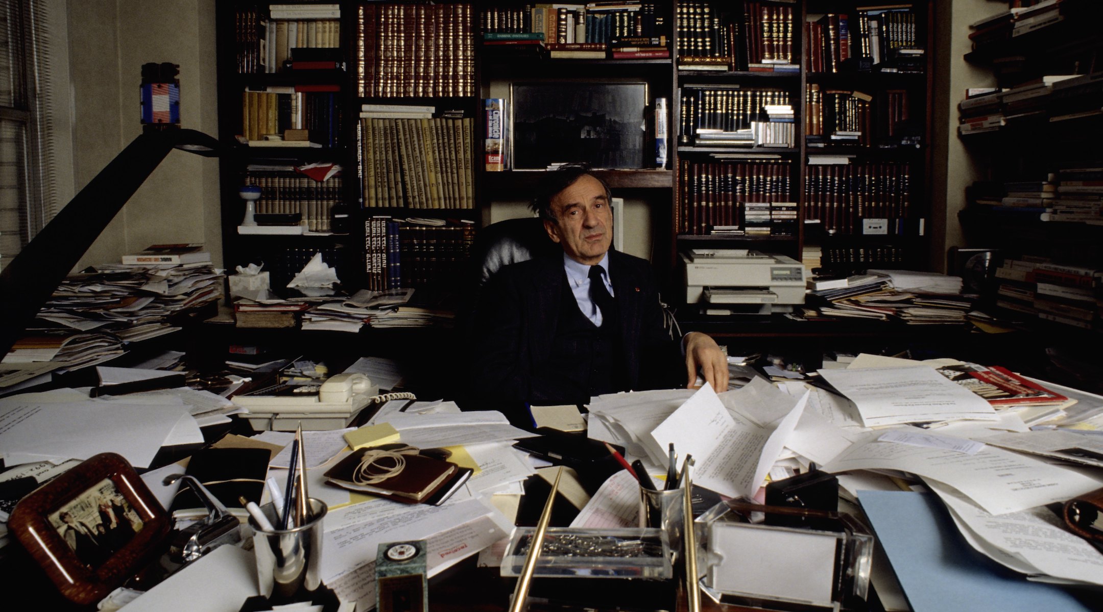 The author and Holocaust survivor Elie Wiesel in his office in 1980, surrounded by books and papers