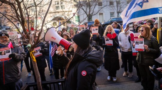 Protest leader Shany Granot-Lubaton leads a crowd outside the home of U.N. Secretary-General Antonio Guterres, January 5, 2024. (Luke Tress)