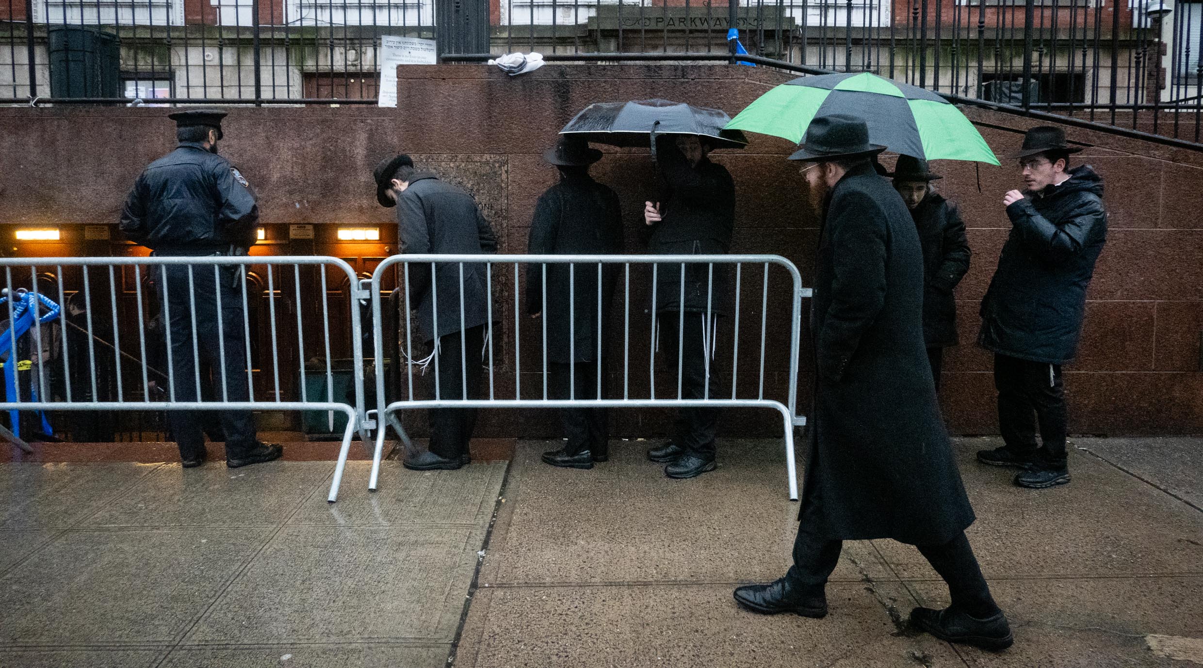 Worshipers line up to retrieve items from a storage room outside the main synagogue at Chabad headquarters, Jan. 9, 2024. (Luke Tress)