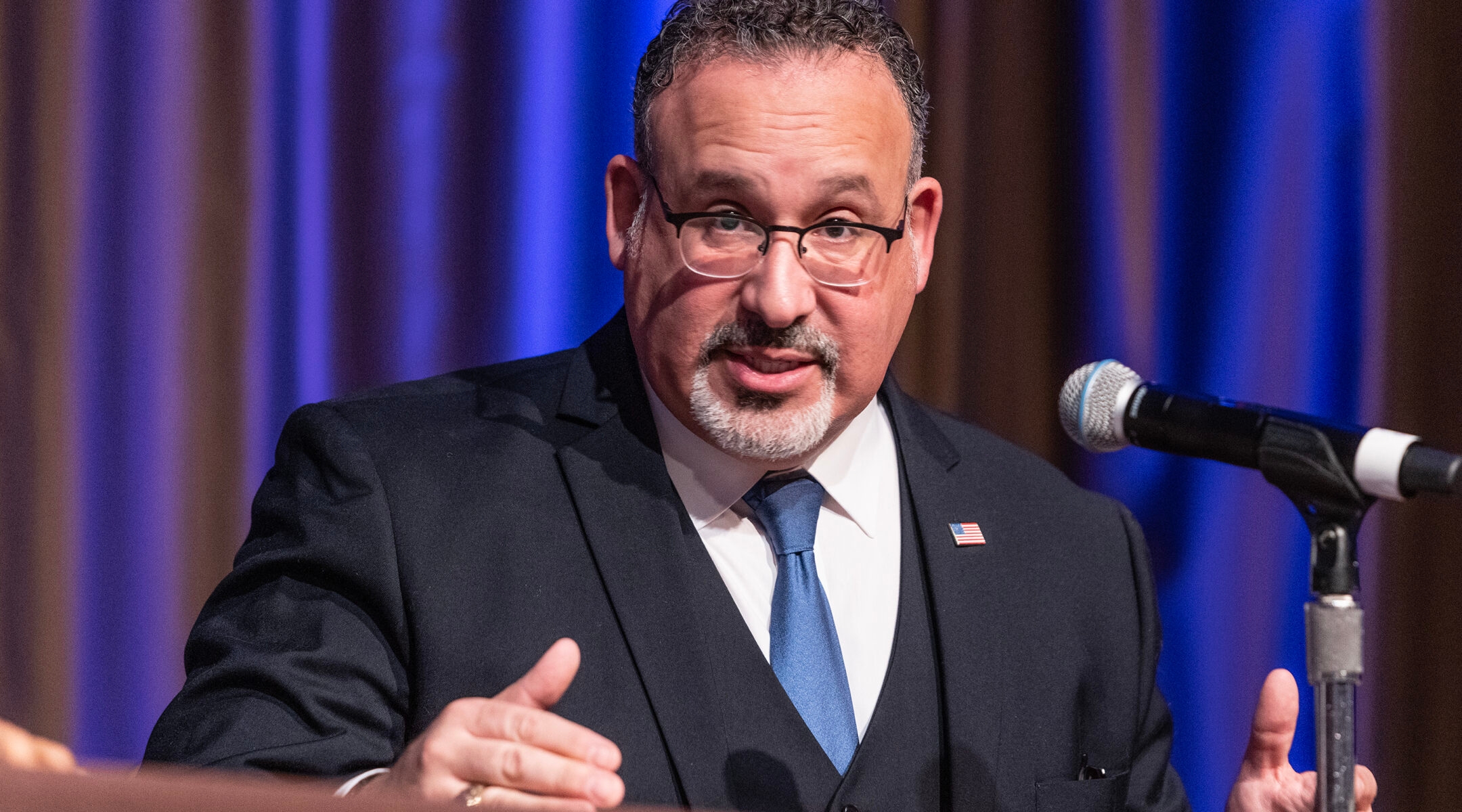 U.S. Secretary of Education Miguel Cardona at a podium