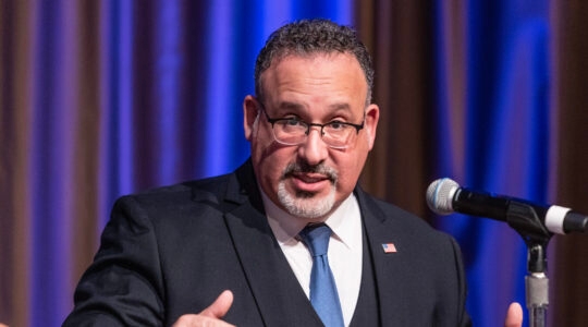 U.S. Secretary of Education Miguel Cardona at a podium