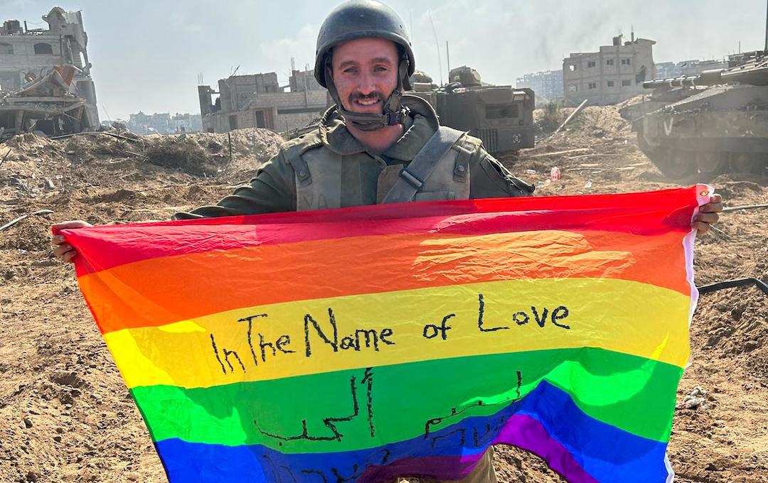 Yoav Atzmoni holding a Pride flag in Gaza. (Courtesy of Atzmoni)