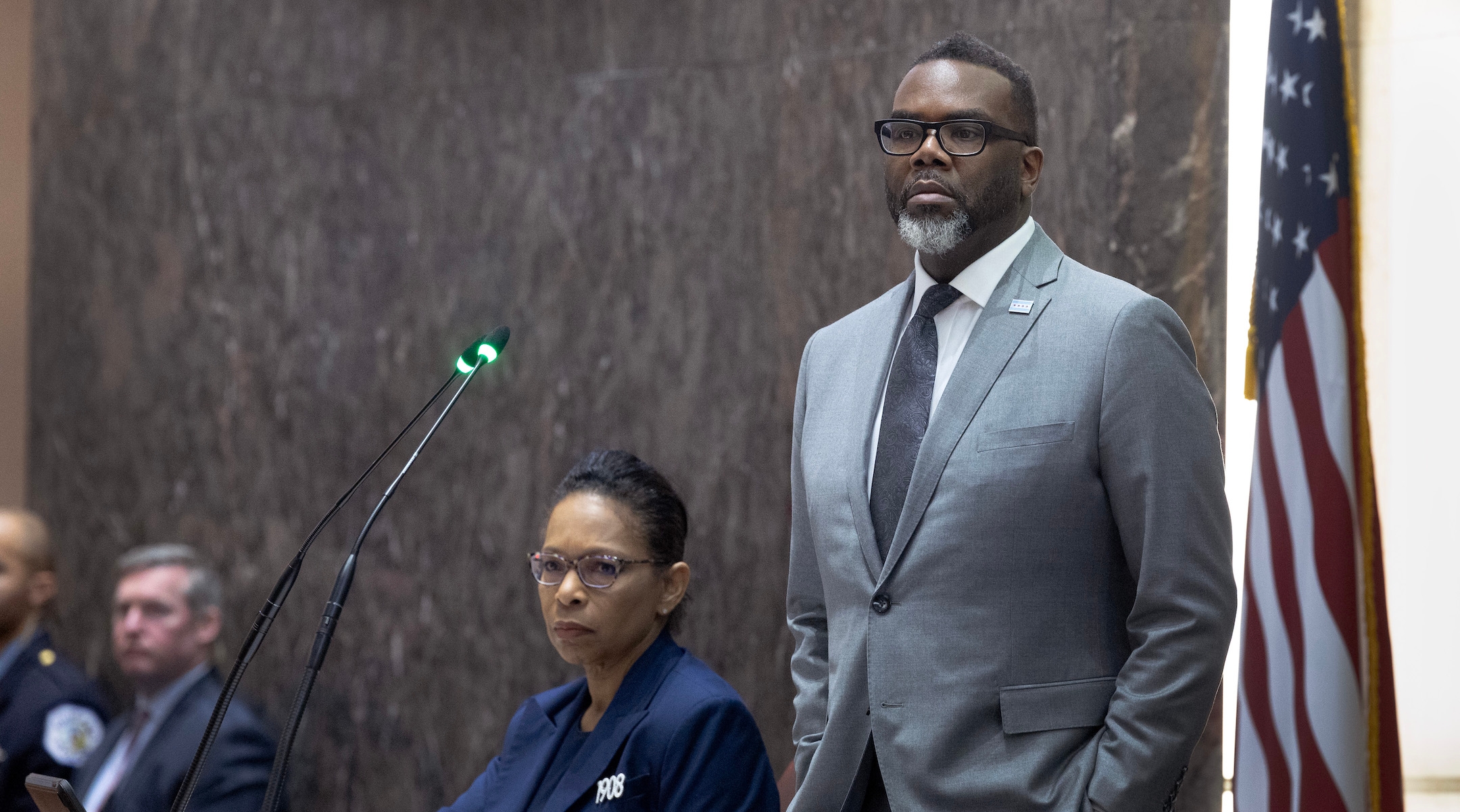 Chicago Mayor Brandon Johnson stands during a city council meeting