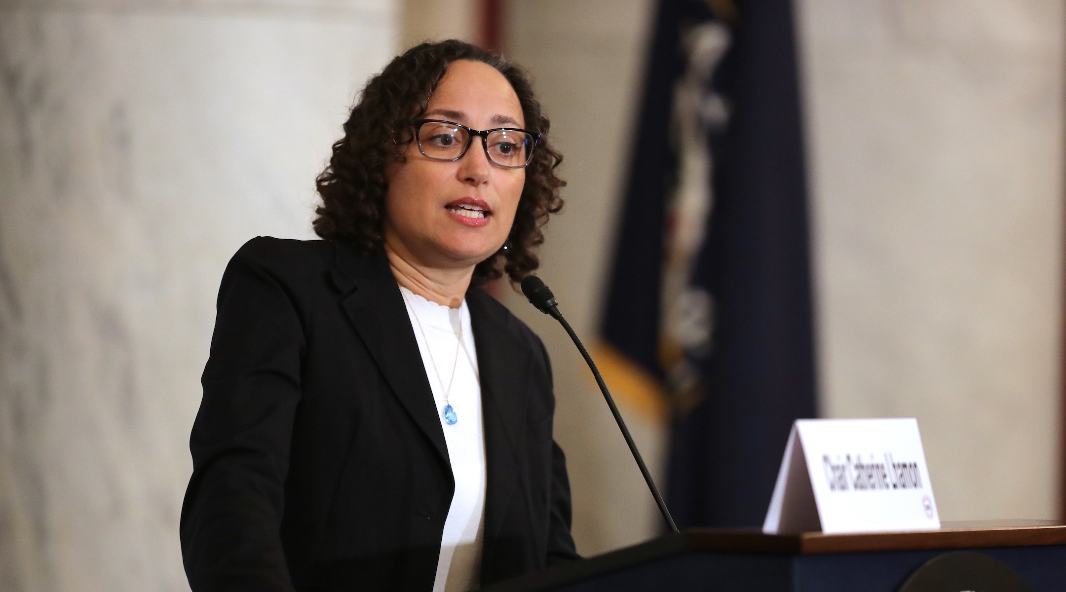 A woman delivering a speech at a podium