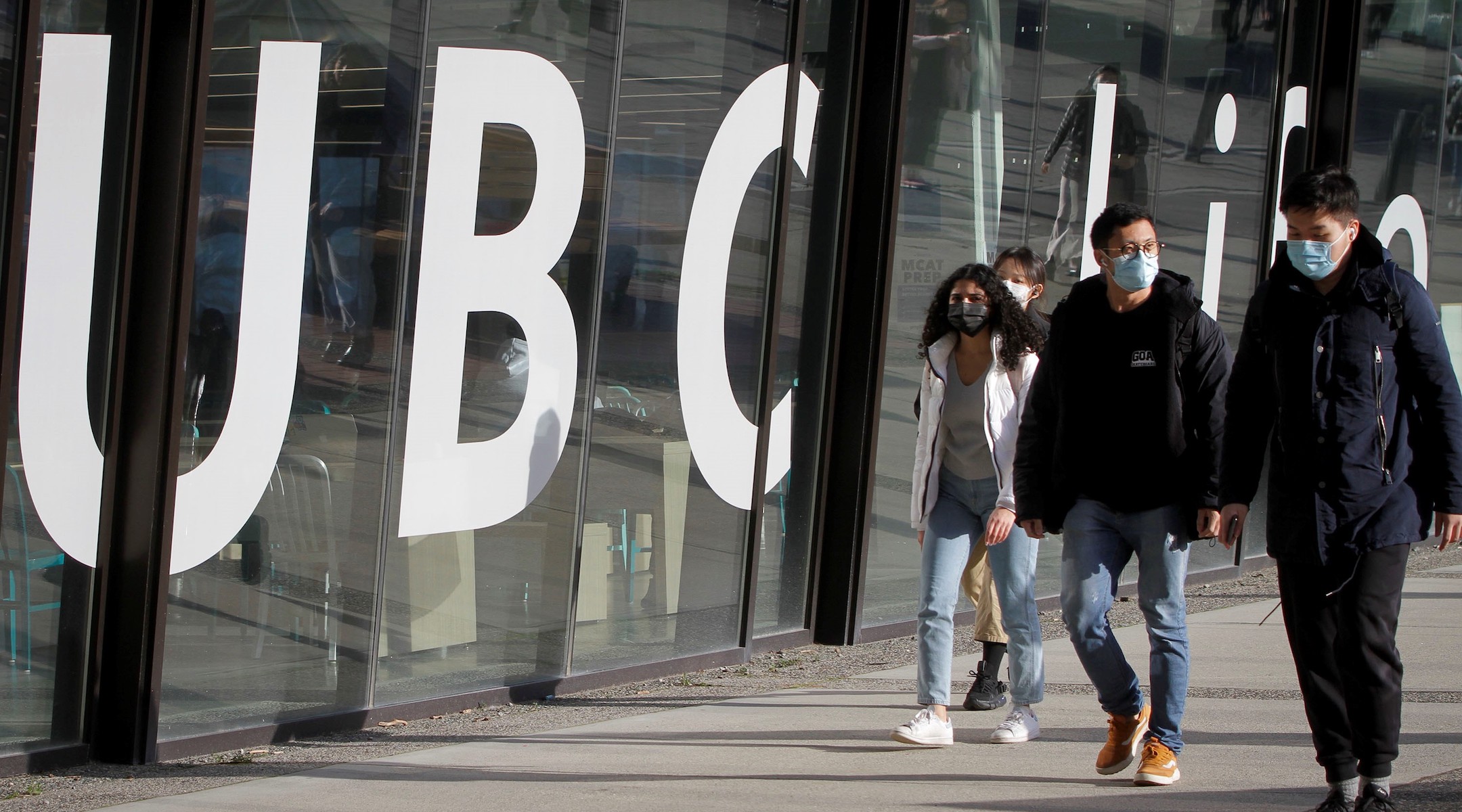 Students walking by a college campus building