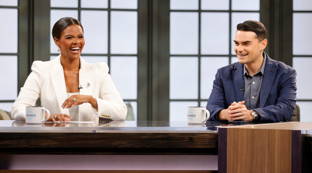 Two conservative pundits behind the desk of a talk show