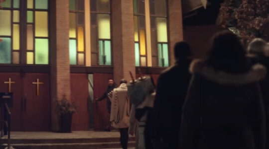 People walking into a church with a Torah
