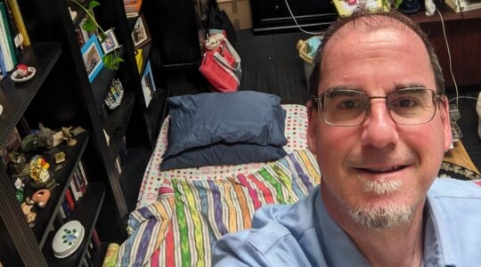 A professor takes a selfie of himself sleeping in his office