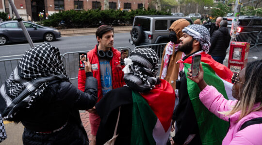 Pro-Palestinian demonstrators surround a Jewish man at a protest outside Columbia University, in Manhattan, April 18, 2024. (Luke Tress)
