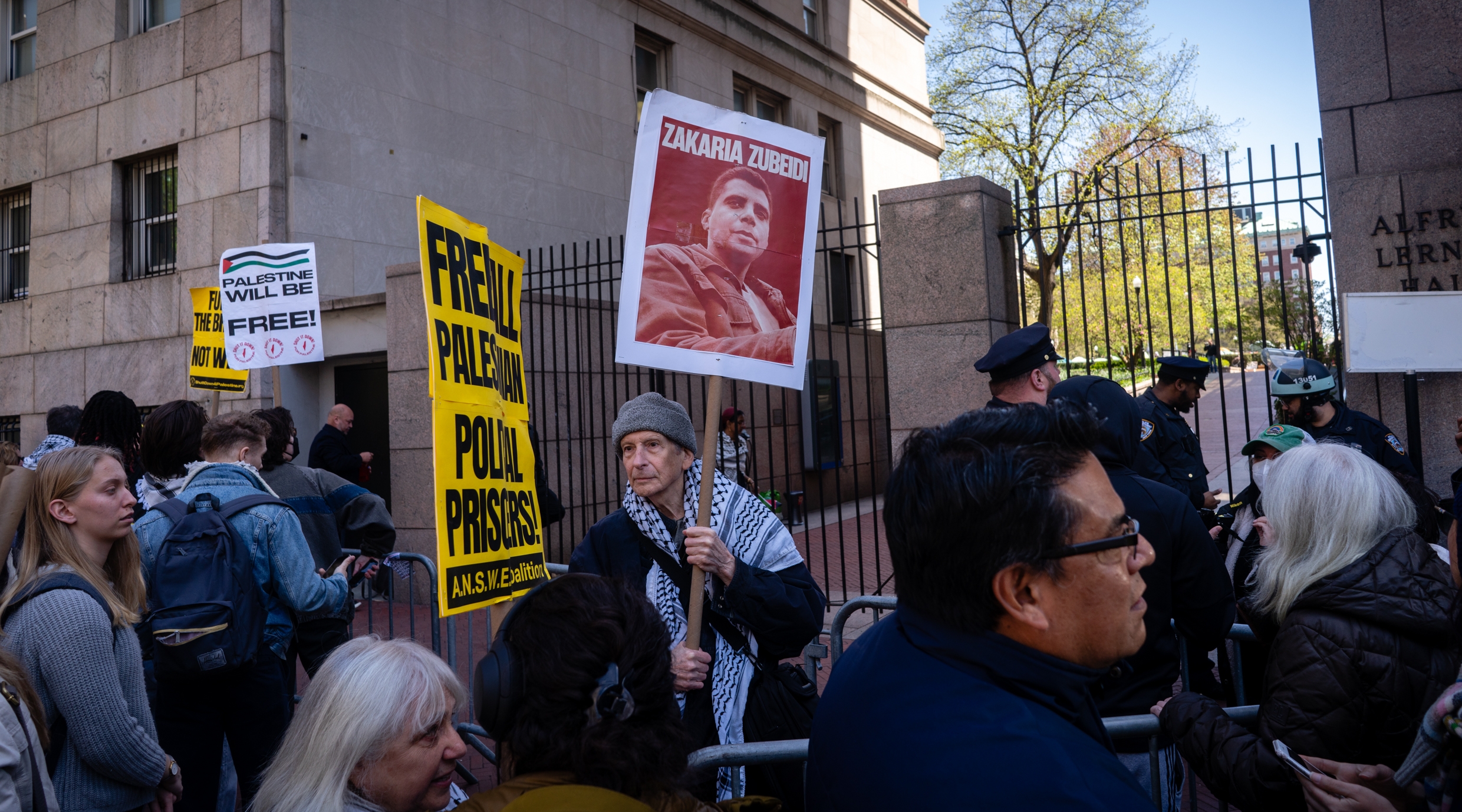 A demonstrator holds a photo of convicted terrorist Zakaria Zubeidi outside of Columbia University, April 22, 2024. (Luke Tress)