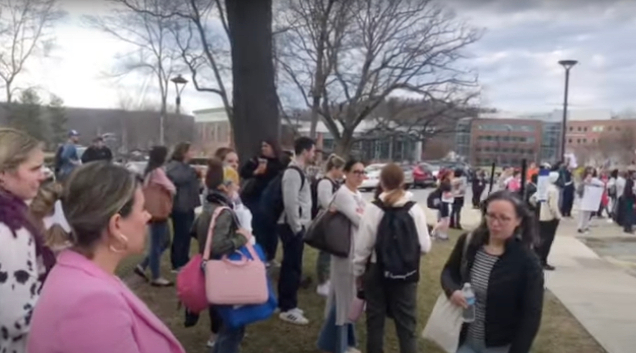 People standing outside a university after a fire alarm