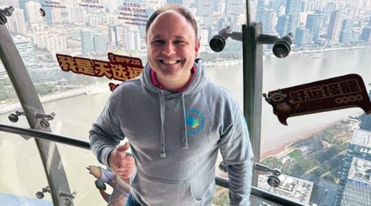 David Weiner, admissions director and enrollment manager at Kehillah Jewish High School in Palo Alto, California, atop the Oriental Pearl Tower in Shanghai, on a visit to recruit Chinese students in March 2024. (Courtesy)