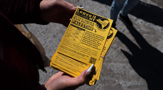 A campaigner in Queens holds a Leave it Blank flyer ahead of New York’s presidential primary, March 29, 2024. (Adam Gray/Getty Images)