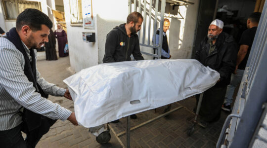 People receive the bodies of World Central Kitchen workers who were killed by Israeli air strikes on April 2, 2024 in Rafah, Gaza. (Ahmad Hasaballah/Getty Images)