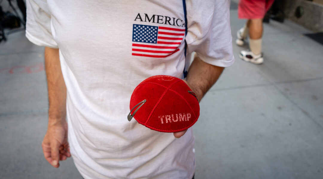 Ariel Kohane, a supporter of Donald Trump, holds a Trump kippah in front of Trump Tower in midtown Manhattan, Nov. 6, 2024. (Luke Tress)