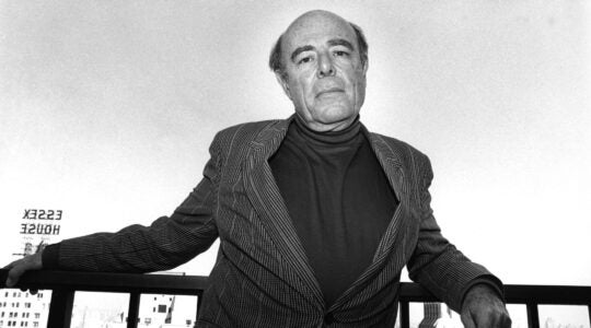 A film director poses on a balcony