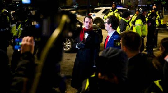 Trump staffer Paul Ingrassia waits outside at night for Jan. 6 defendants to be freed