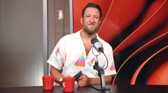 Dave Portnoy smiling behind a microphone