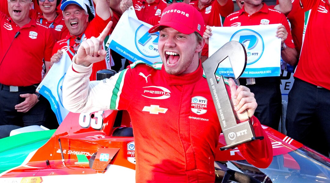 IndyCar driver Robert Shwartzman poses for a group photo with his team after winning the pole award as the fastest qualifier for the 109th running of the Indianapolis 500 on May 18, 2025, at the Indianapolis Motor Speedway in Indianapolis, Indiana. (Brian Spurlock/Icon Sportswire via Getty Images)