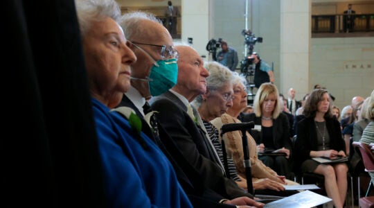 Holocaust survivors watching a speech