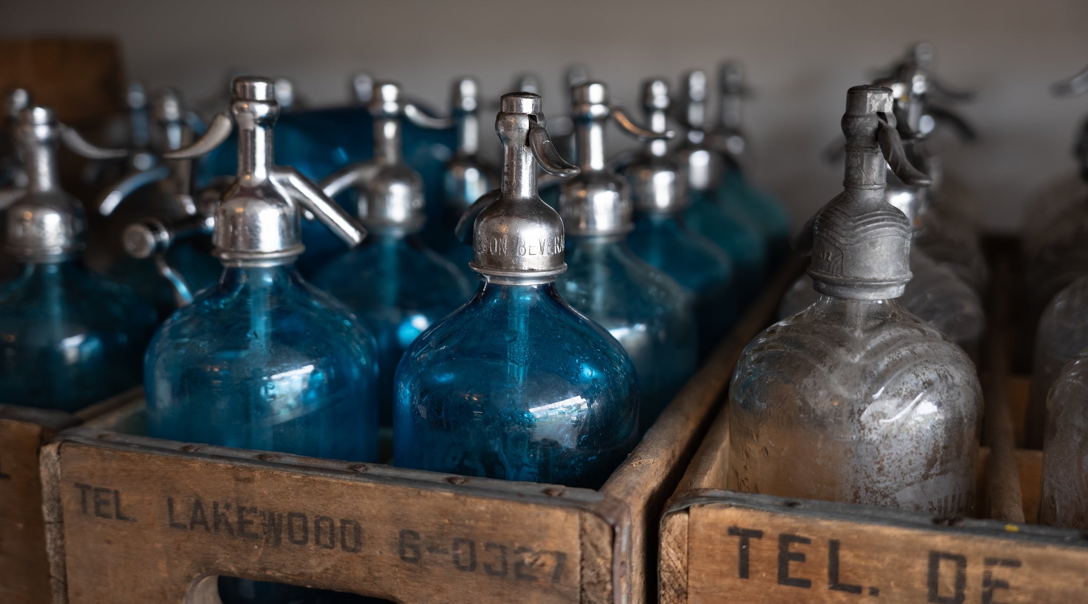 Seltzer bottles in old wooden crates