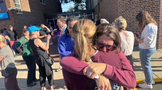Parents embrace outside of the annunciation school.