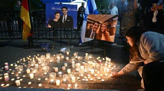 a candlelit vigil for sarah milgrim and yaron lashinsky.