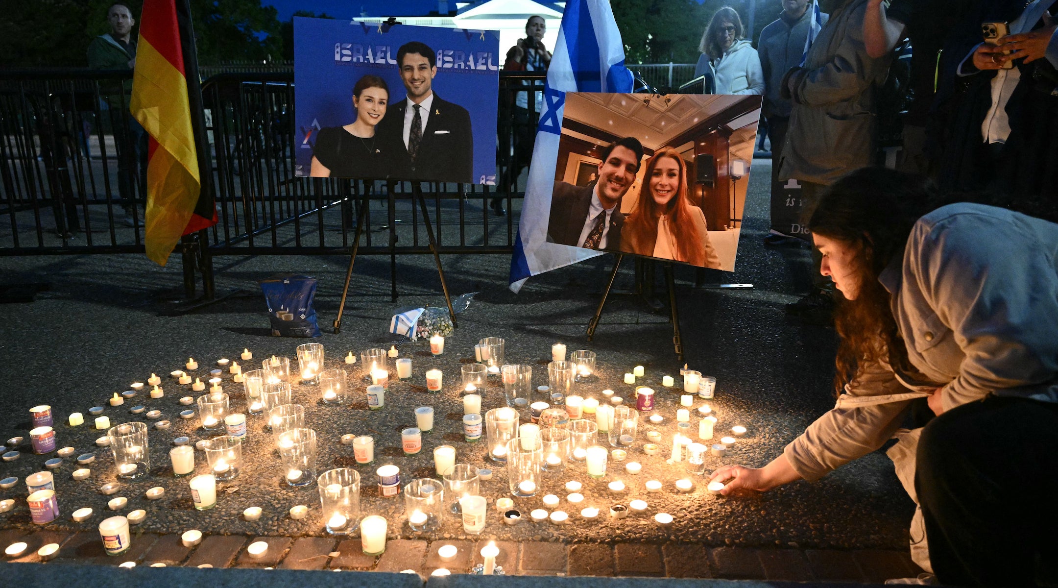 a candlelit vigil for sarah milgrim and yaron lashinsky.