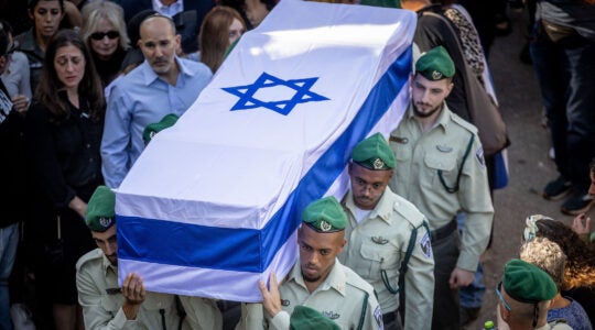 Soldiers carrying a casket draped in the Israeli flag.
