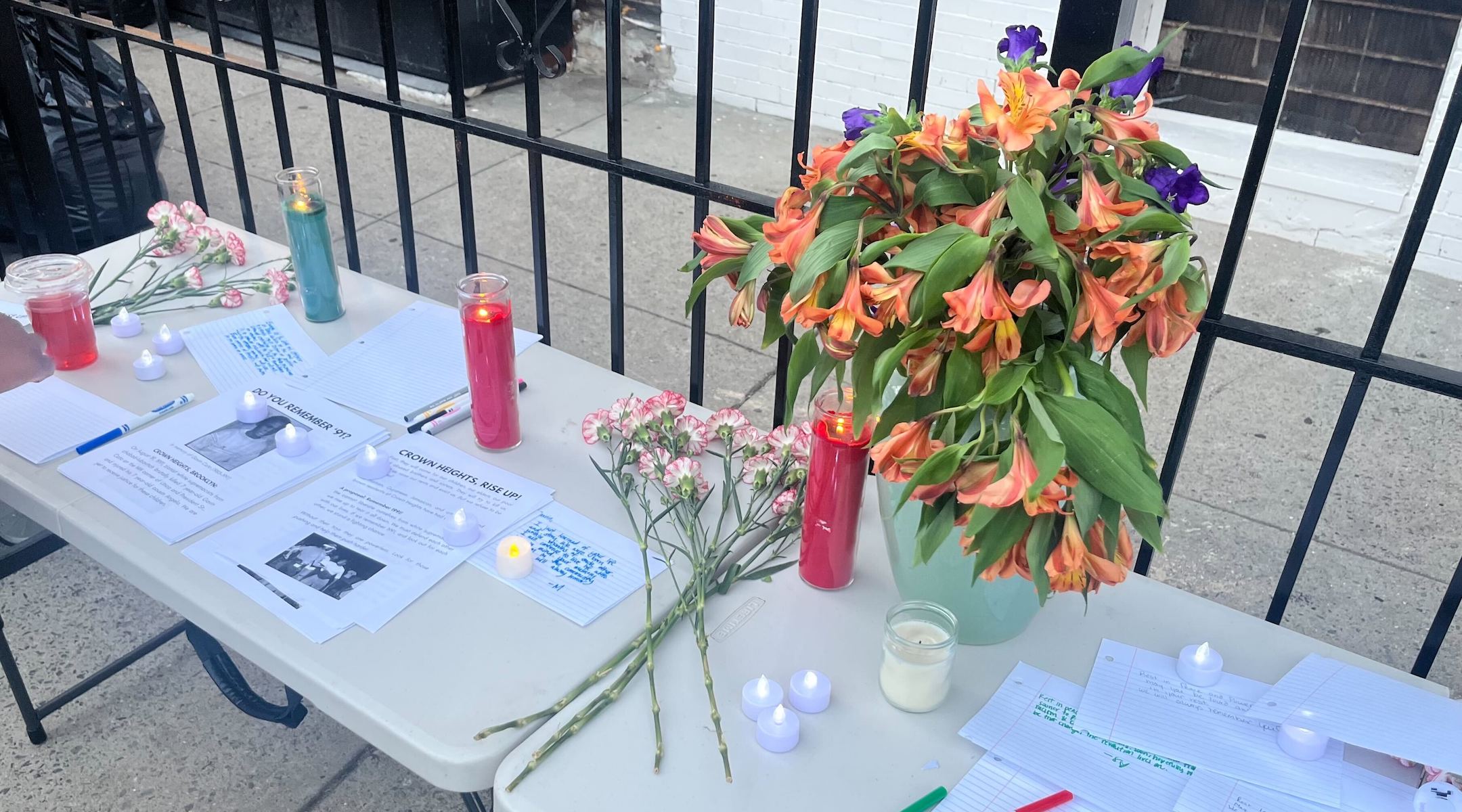 A photo of the vigil table with candles and flowers.
