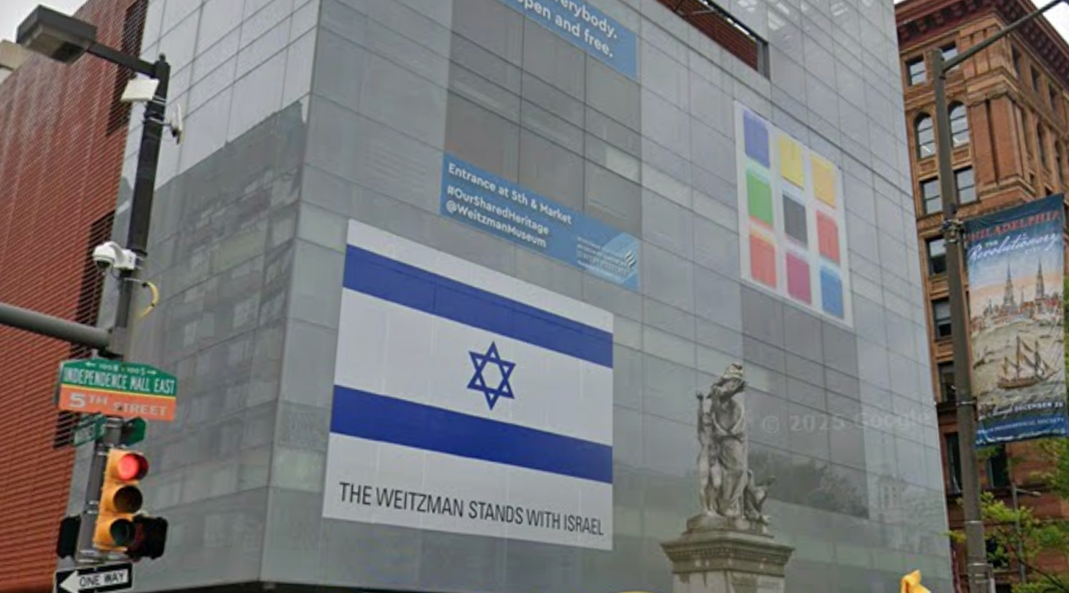 A photo of the facade of the The Weitzman National Museum of American Jewish History in Philadelphia with the Israeli flag.