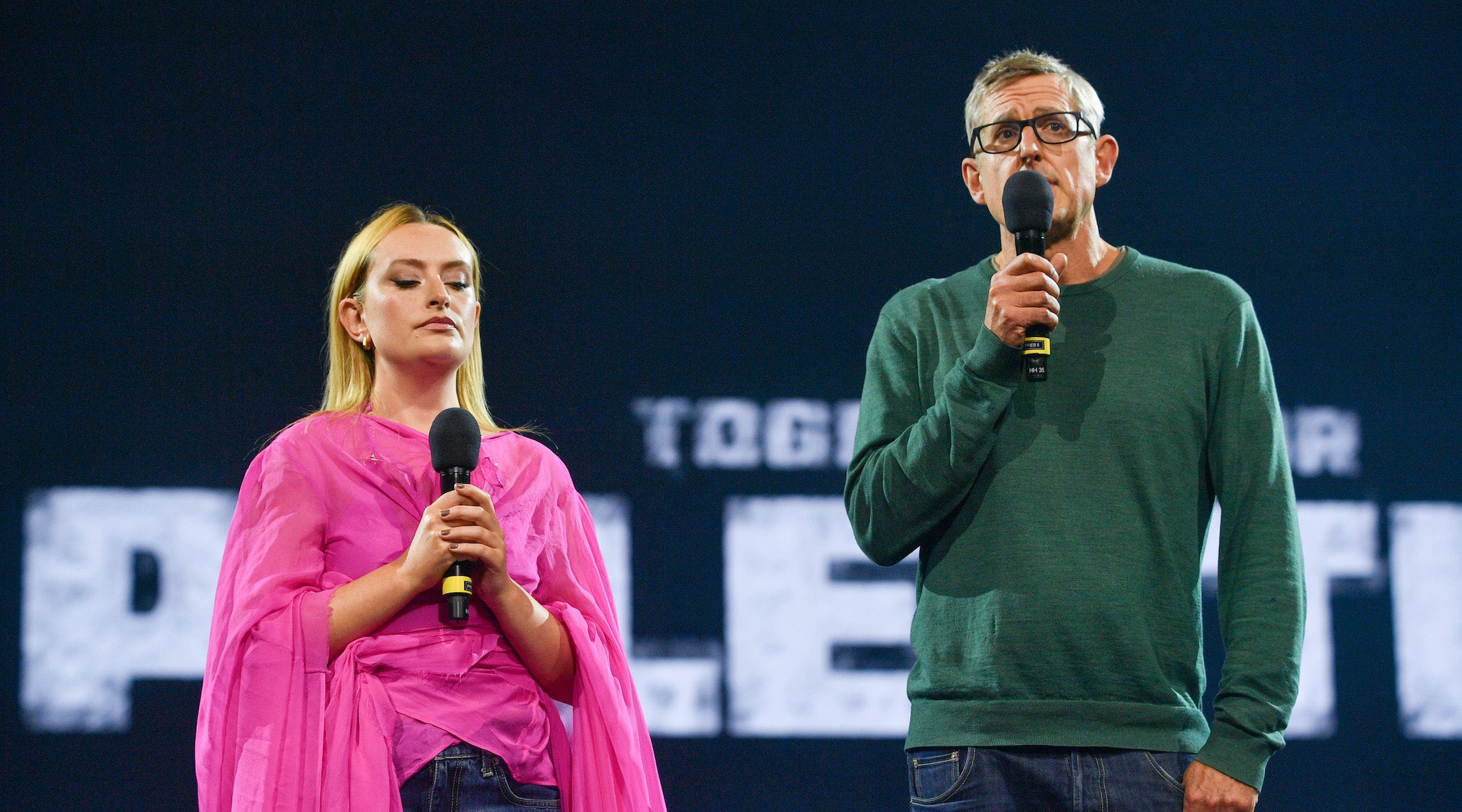 Amelia Dimoldenberg and Louis Theroux onstage at a pro-Palestinian concert