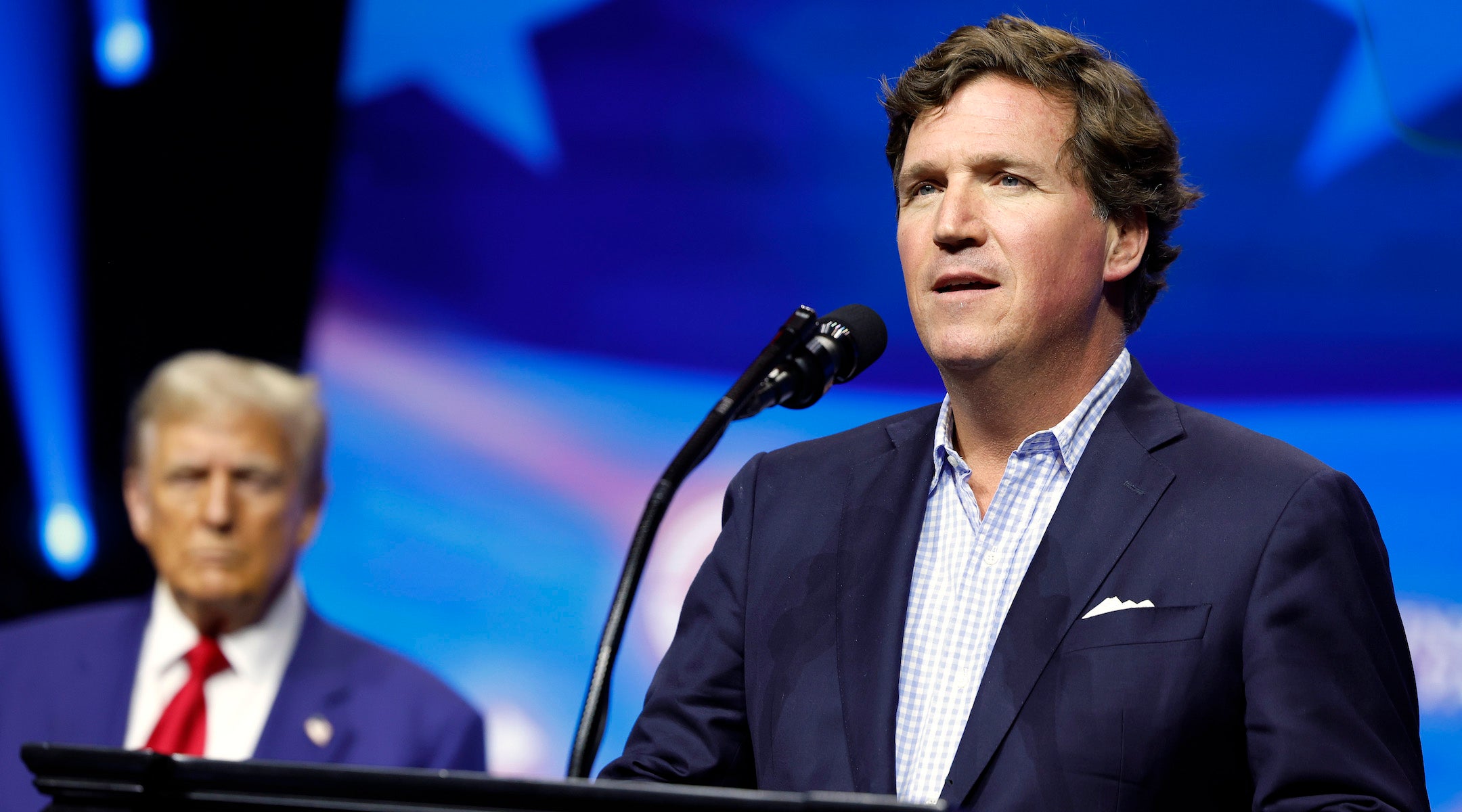 Tucker Carlson introduces Donald Trump at a rally