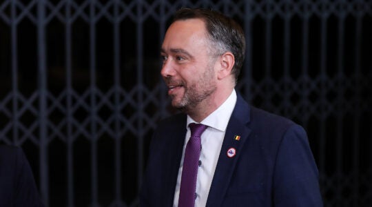 A photo of Maxime Prévot in a suit smiling.