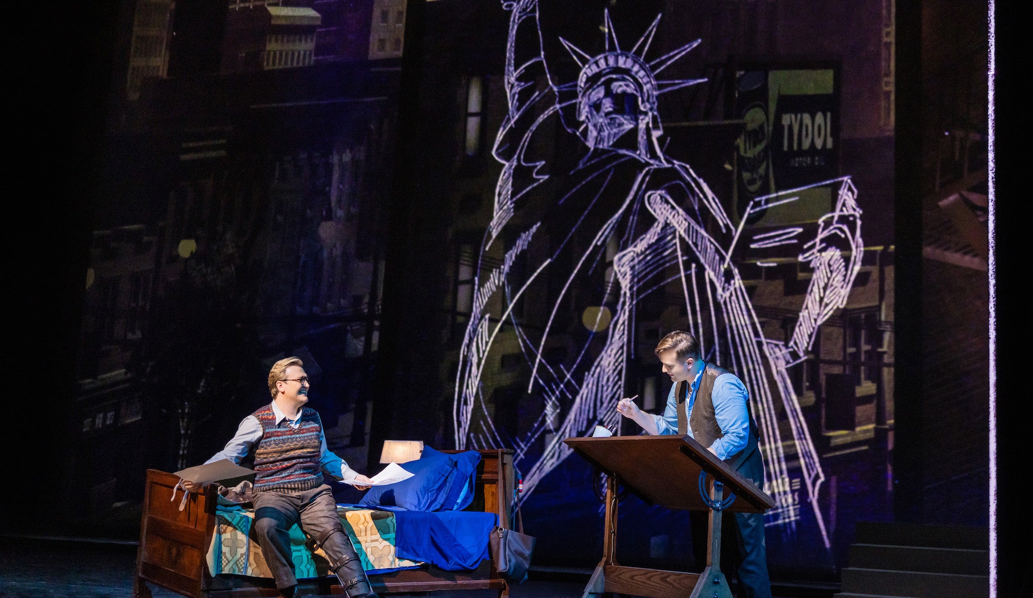 Two actors an a drawing of the Statue of Liberty in a scene from "The Amazing Adventures of Kavalier & Clay."