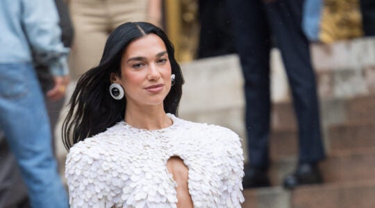 A photo of Dua Lipa in a white dress.
