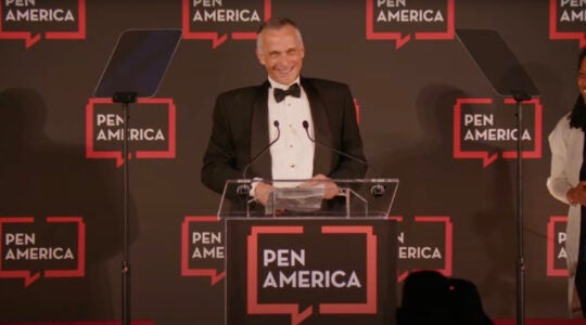 Michael Roth accepts an award