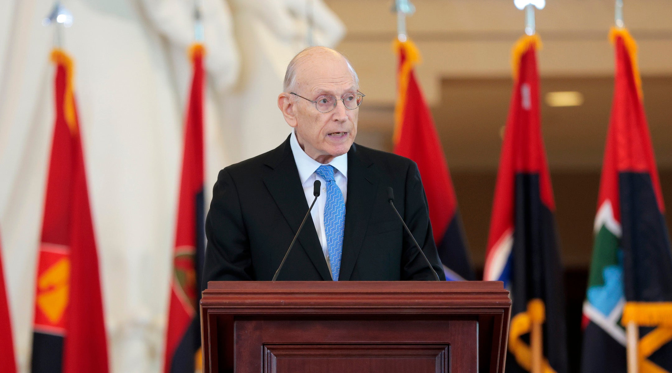 A photo of Eizenstat speaking from a podium.