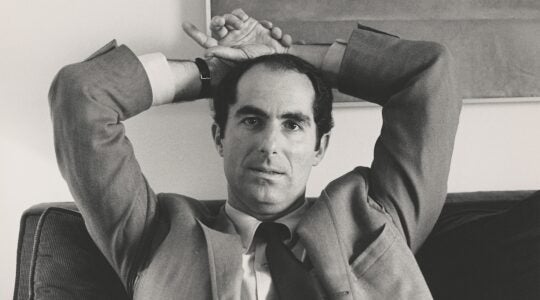 Jewish man with his arms over his head