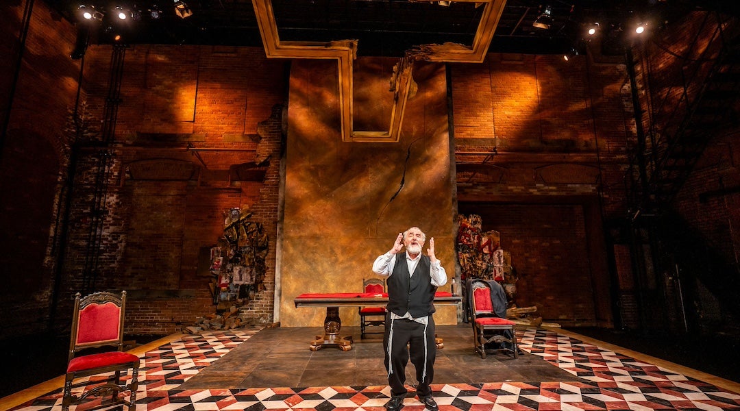 An actor onstage dressed as Shylock.