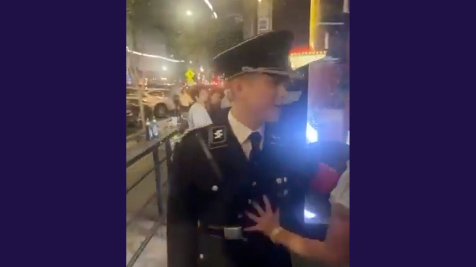 A man wearing a nazi uniform is pushed by a hand off camera.