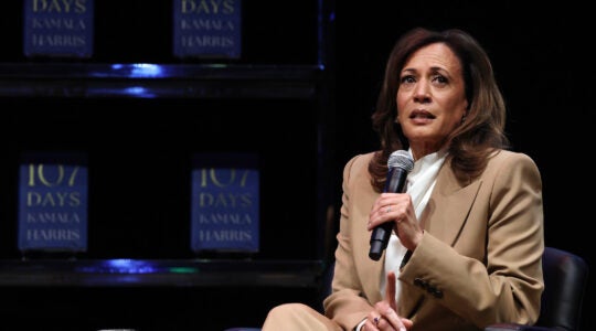 A photo of Harris speaking into a mic.