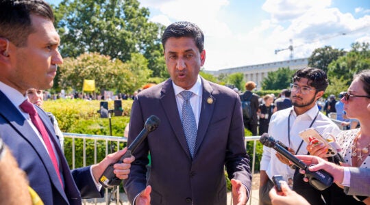 A photo of Khanna speaking with reporters.